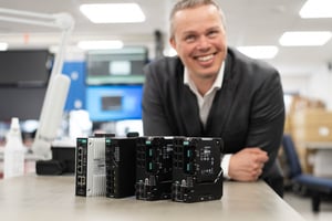 The picture shows Gøran Labrå, Senior Key Account Manager at Hatteland Technology, with a selection of Moxa switches. He is smiling.