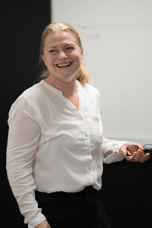 Safety- and tunnel engineer Mia Skrataas from Hatteland Technology is facing the camera, smiling. She is wearing a white shirt. 