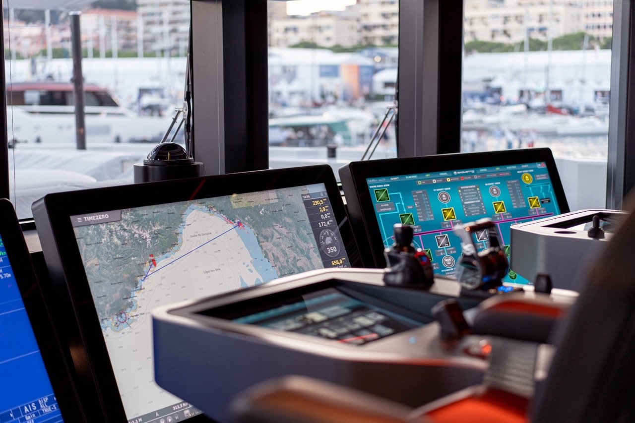 A close-up of the captain’s chair on the bridge of superyacht Baglietto T52, which is equipped with Furuno's integrated bridge system for the yacht market. The yacht was part of the exhibition at the Monaco Yacht Show 2023. The navigation software TimeZero is loaded on one of the three Hatteland Technology 55-inch screens. In the background you can see the bay of Monaco.