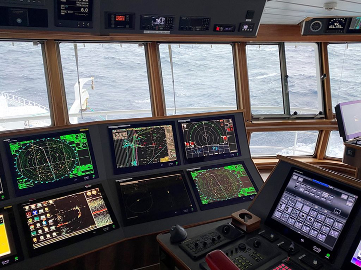 The photo shows a ship's bridge with plenty of Hatteland Technology monitors, as part of a Furuno navigation system. 