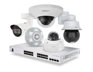 The picture shows a collection of Hatteland Technology Sweden's products, including surveillance cameras and ethernet switches. Brands seen include Bosch, Axis, Wisenet, and Cisco.