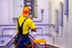 electrical_cabinet_man_working_AdobeStock_306897488