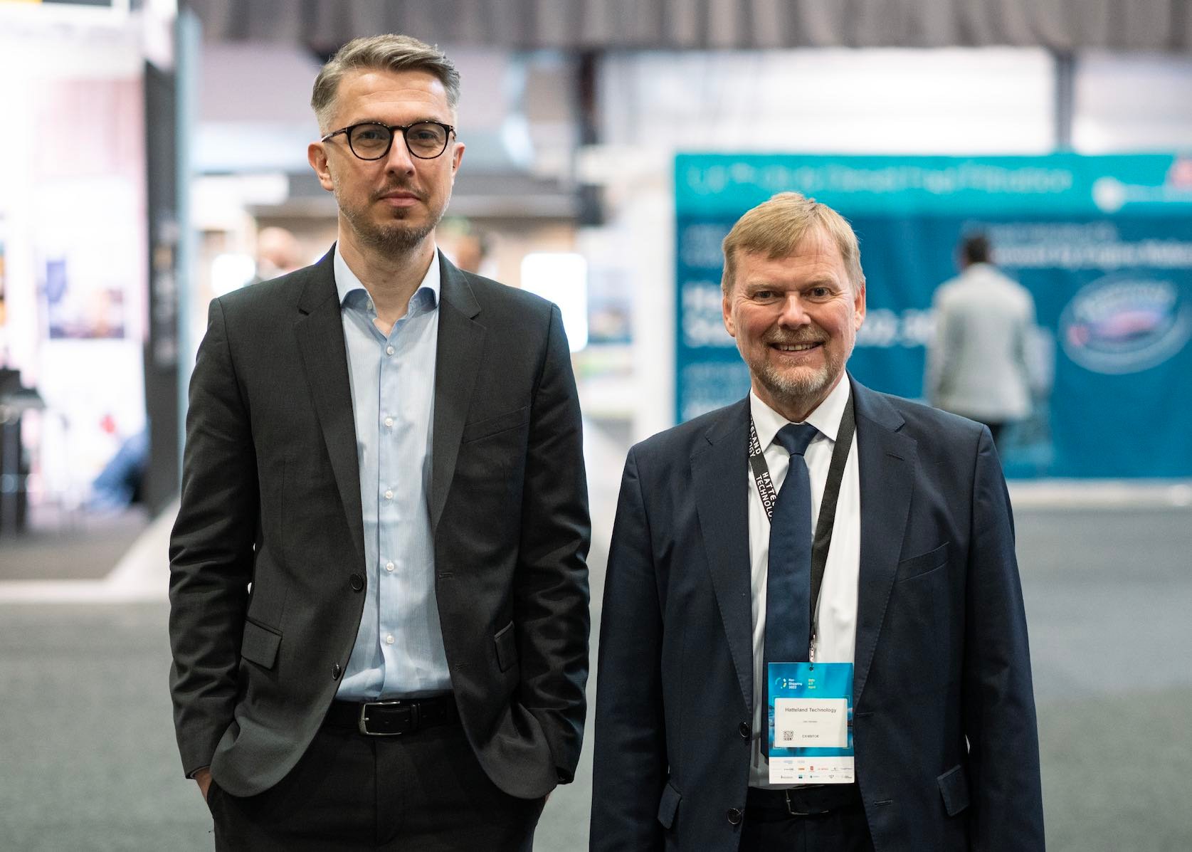 Captain Jan Hansen and Mr. Jakub Kwiatowski from Hatteland Technology, at Nor-Shipping 2022. They are both wearing suits, and are facing the camera. 