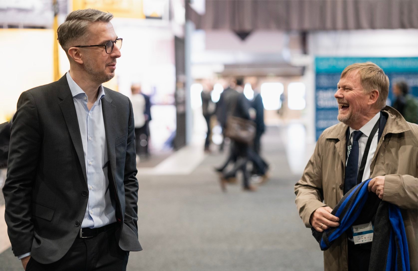 Captain Jan Hansen and Mr. Jakub Kwiatowski from Hatteland Technology, at Nor-Shipping 2022. They're seen having fun, both laughing.  