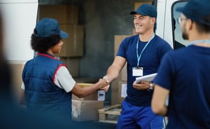 happy-delivery-man-greeting-with-his-female-cowork-2023-11-27-05-31-55-utc