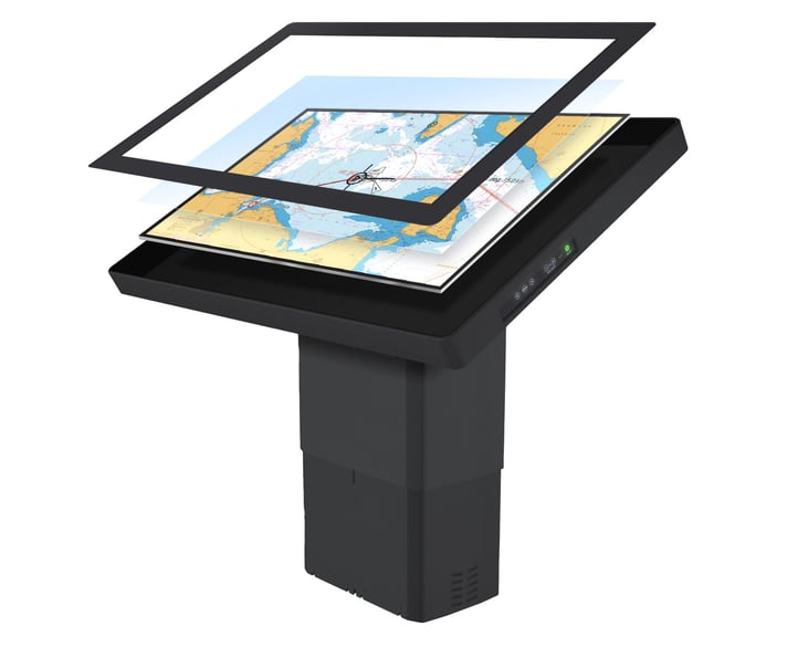 Hatteland Technology's HD55 electronic chart table is seen in exploded view, with the screen elements detached from the front. The display shows a nautical chart. The monitor rests on the motorised floor stand. 
